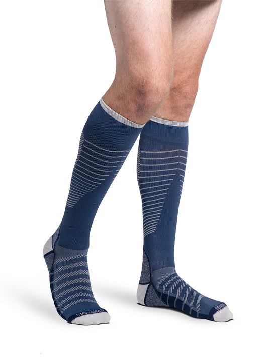 Man wearing Sigvaris Motion Flow Tech compression socks in the color Deep Sea