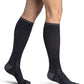 Woman wearing Sigvaris Motion Flow Tech compression socks in the color Black