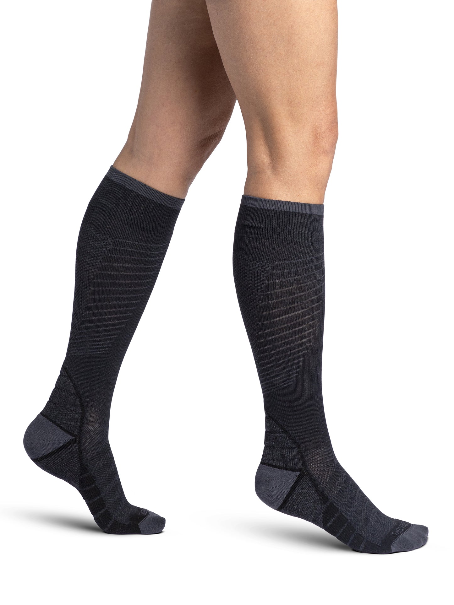 Woman wearing Sigvaris Motion Flow Tech compression socks in the color Black