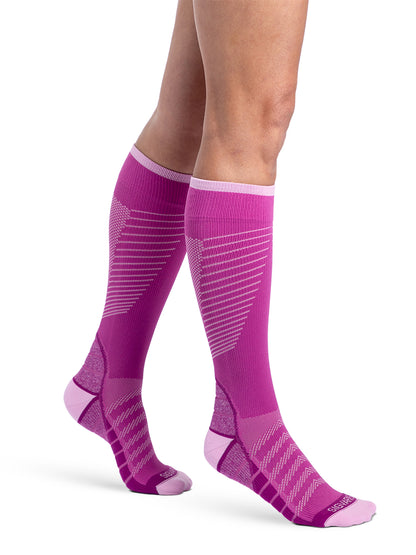 Woman wearing Sigvaris Motion Flow Tech compression socks in the color Orchid