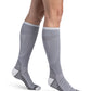 Woman wearing Sigvaris Motion Flow Tech compression socks in the color Cool Grey