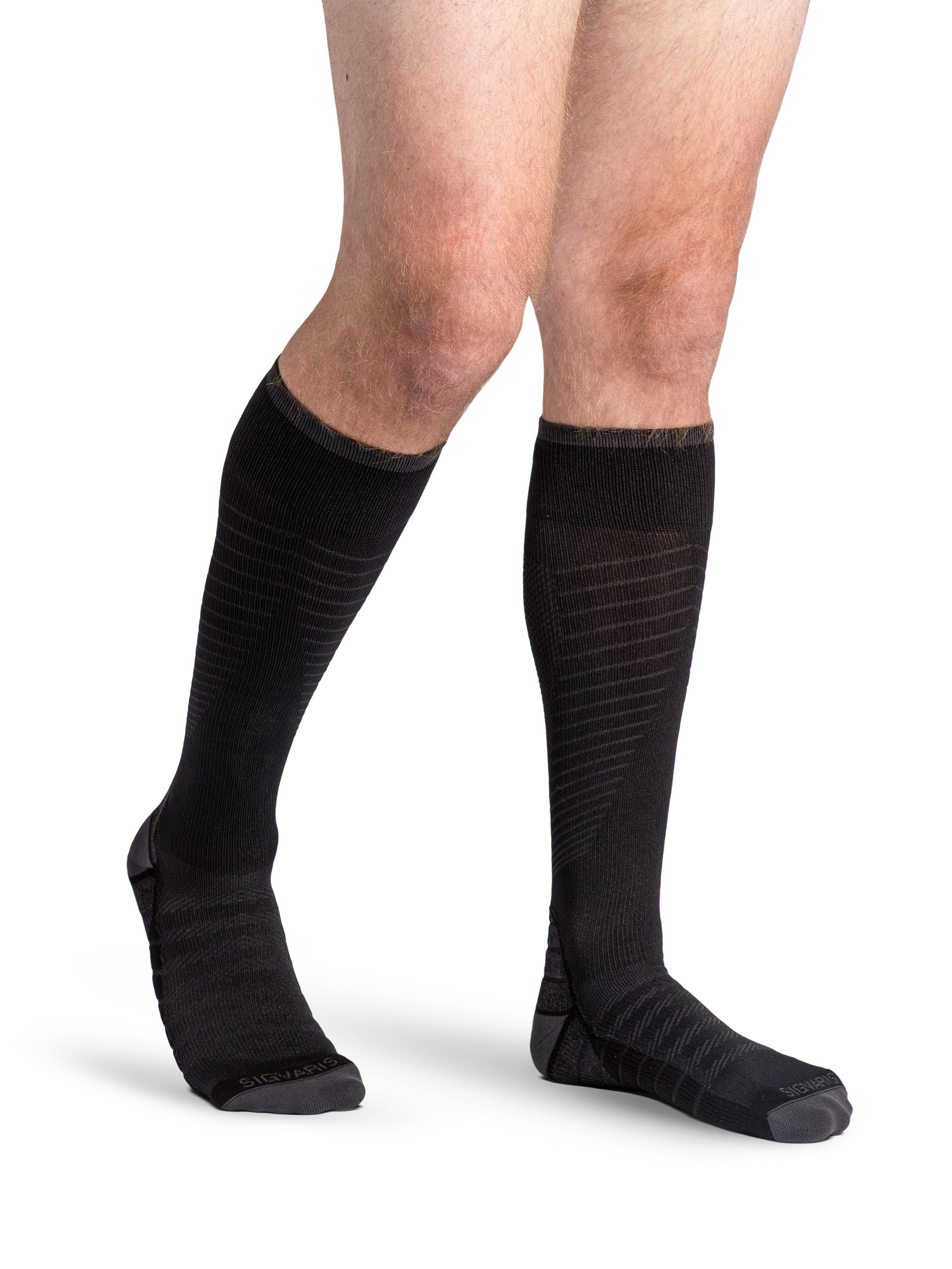 Man wearing Sigvaris Motion Flow Tech compression socks in the color Black