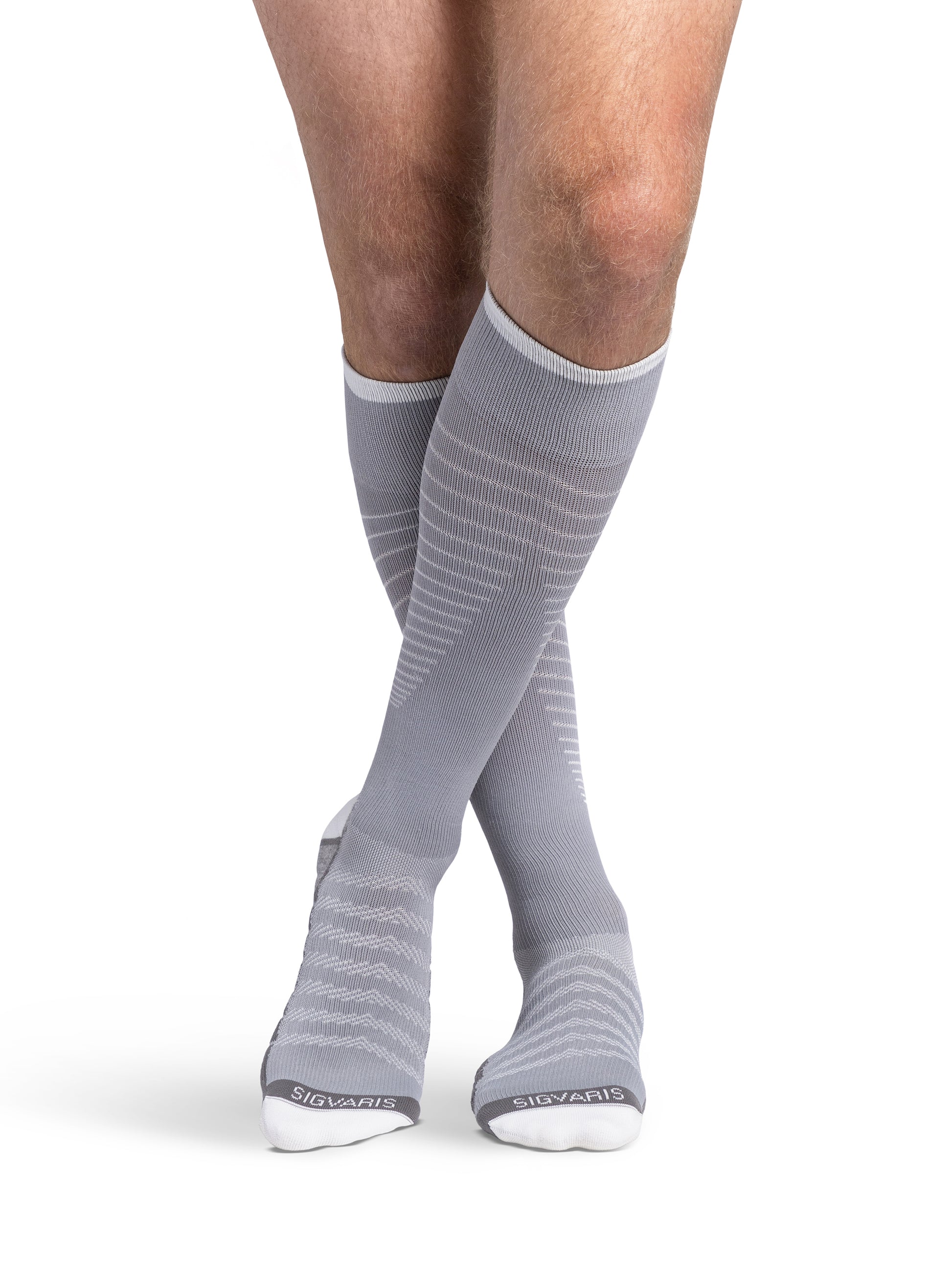 Man wearing Sigvaris Motion Flow Tech compression socks in the color Cool Grey