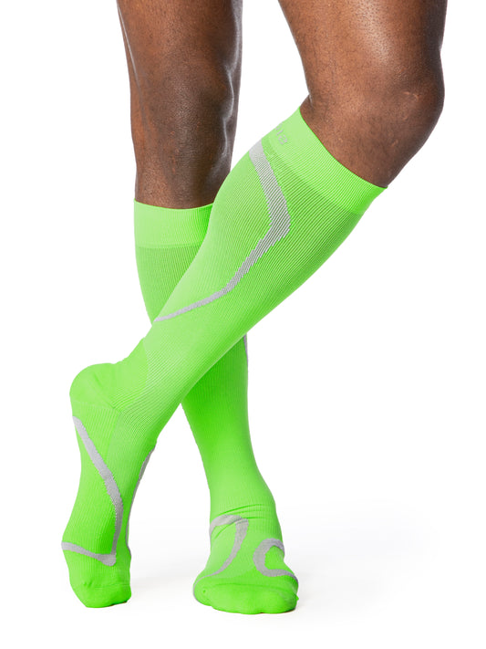 Man wearing Sigvaris Motion High Tech compression socks in the color Lime