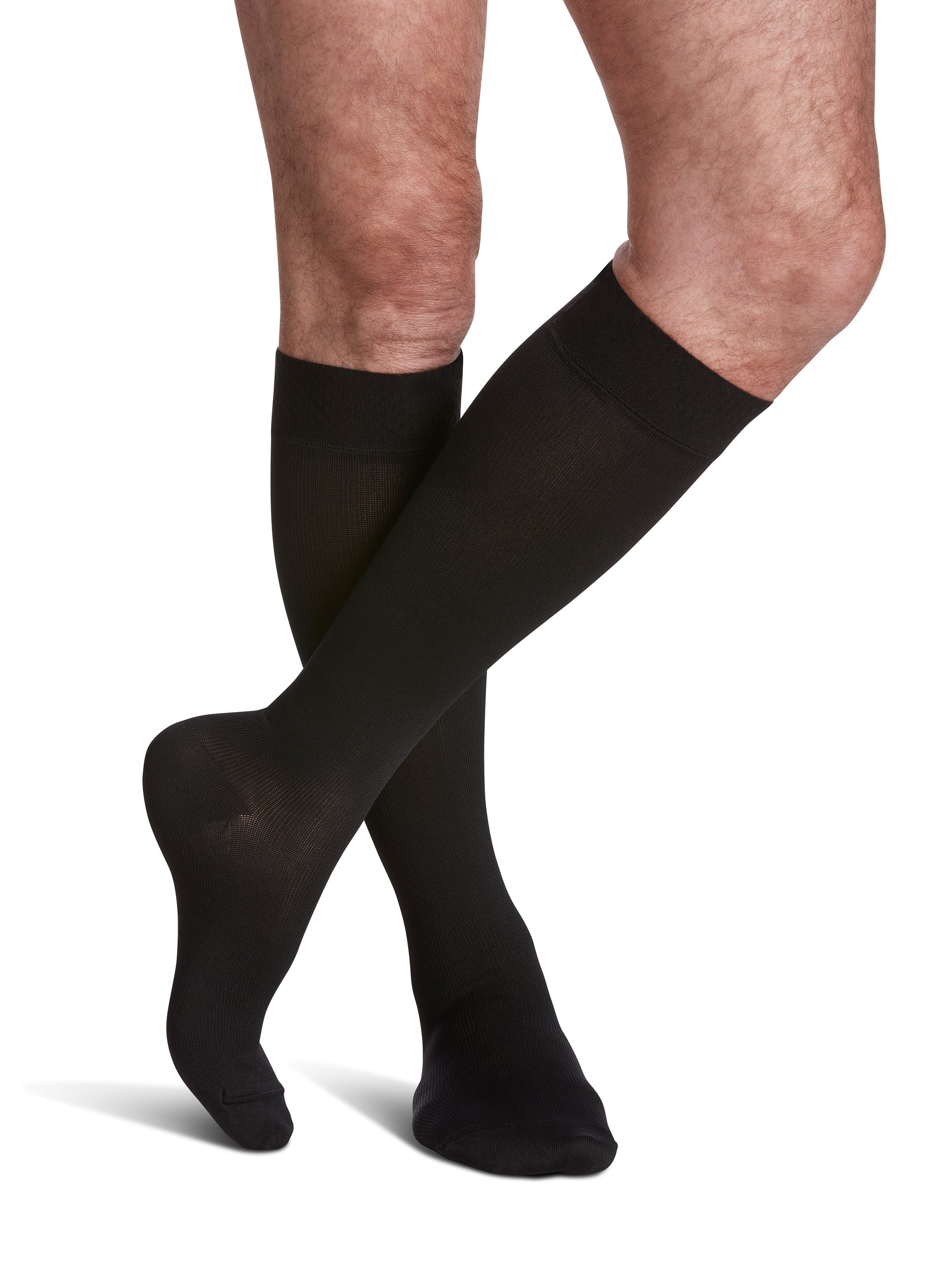 Man wearing Sigvaris Style Microfiber compression socks with grip-top in the color Black