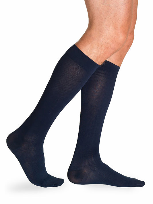 Man wearing Sigvaris Essential Cotton compression socks in the color Navy