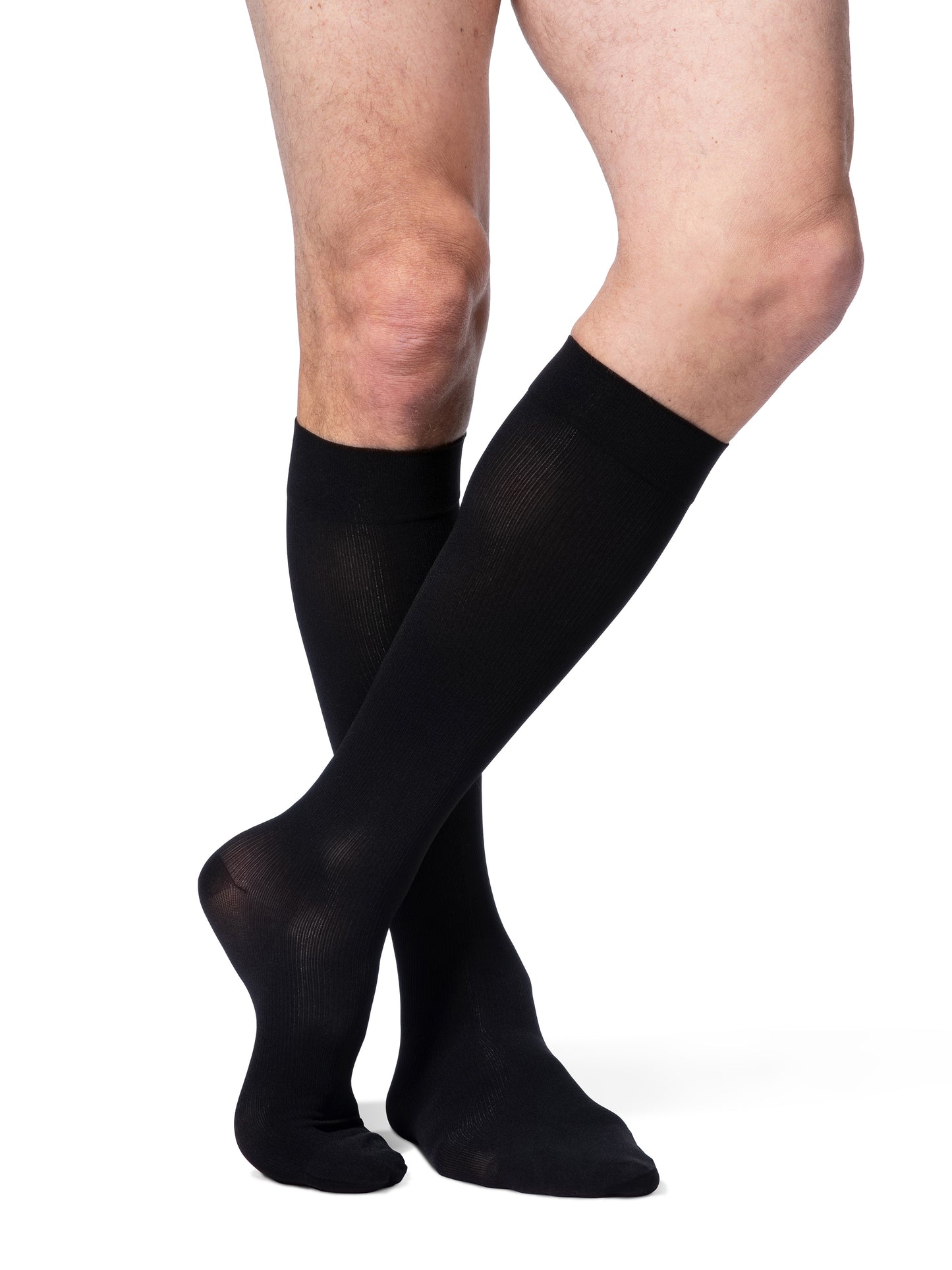 Man wearing Sigvaris Essential Opaque compression socks in the color Black