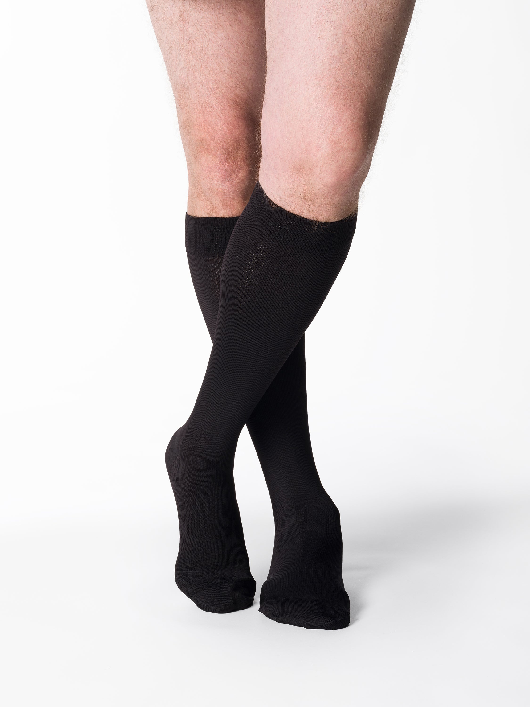 Man wearing Sigvaris Style Microfiber compression socks in the color Black